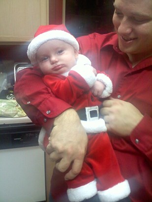 Daddy holding infant RJ in Santa Suit 12 2011