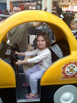 Daddy and Kyla  riding in toy car at San Antonio mall