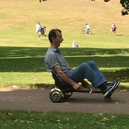 Dad on Grace's hover board speeding around cockington