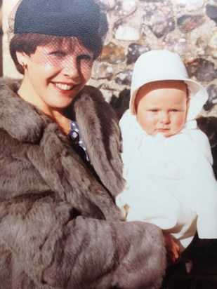 Glamorous in fur holding Ruth at Diane's wedding.