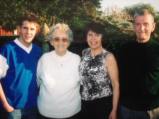 Judy and Grandma with Lewis and Graham in our garden.