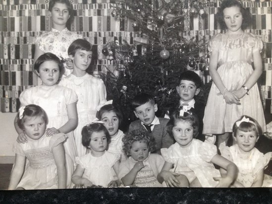  Judy, front left with Liz behind and David centre, at a Christmas Party. All dressed in their best.