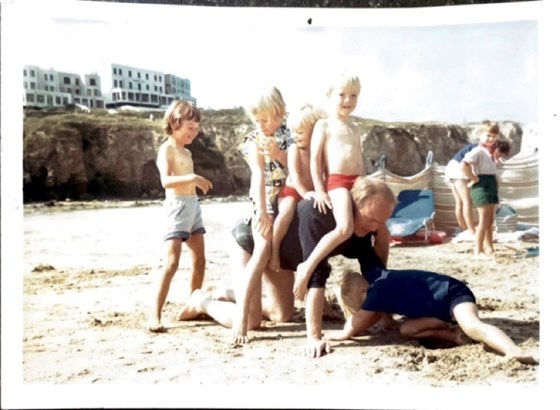 Bill with his Dad, Tony, sister Katie and friends on a beach probably in Cornwall