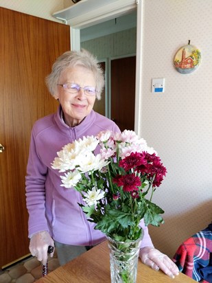 Mum enjoying a gift of flowers