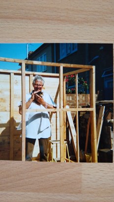 Dad building a shed and holding Guinea pig Emily