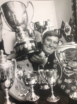 Danny with a selection of trophies won by the Pipeband 