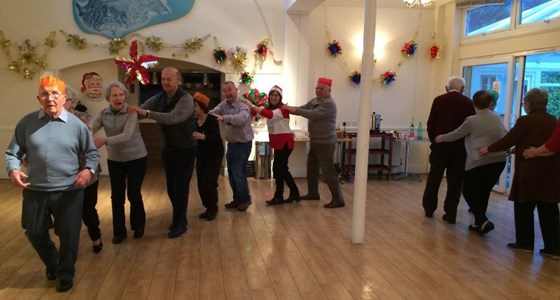 MC leads the conga dance at Dementia Club UK Xmas party 2016
