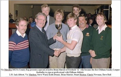 Football presentation - he is the tall one at the back.
