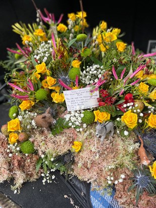 The flower arrangement on Pat's coffin. Themes were of course beautiful flowers and roses, with some of her beloved donkeys and cats to add some mischief!