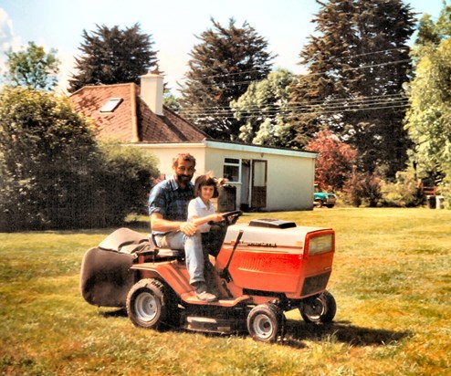 Corinna helping Chris mow the lawn