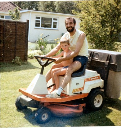 Damian helping Chris mow the lawn