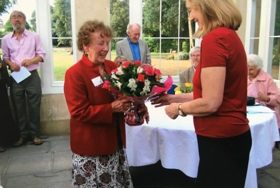 Accepting a bouquet at the Isleworth Society 40th Celebration