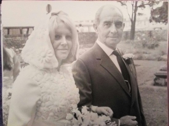 On her wedding day with dad, George.