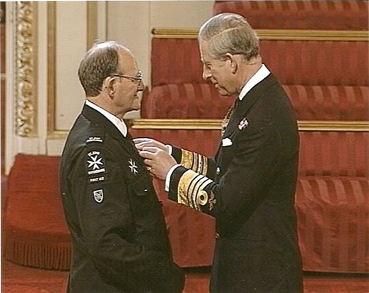 Prince Charles  presenting Peter with his MBE