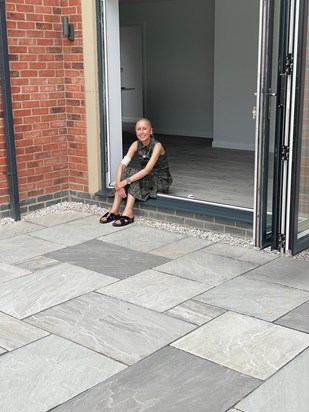 Chuffed with her new house and patio!