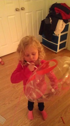 What a big girl!  Danee writing on the balloon for her Momma.