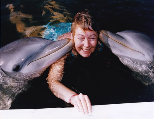 Mum swimming with dolphins