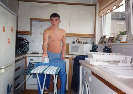 Cha ironing his shirt to go out with his mates.