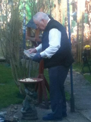 Dad in his garden feeding the birds. 