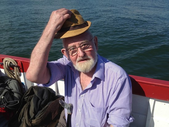 Dad on a boat in Norfolk - unusually choosing to wear a hat and use sunblock in the blazing sun