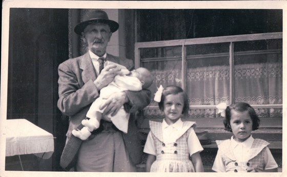 Clare on the right with her older sister and grandpa.