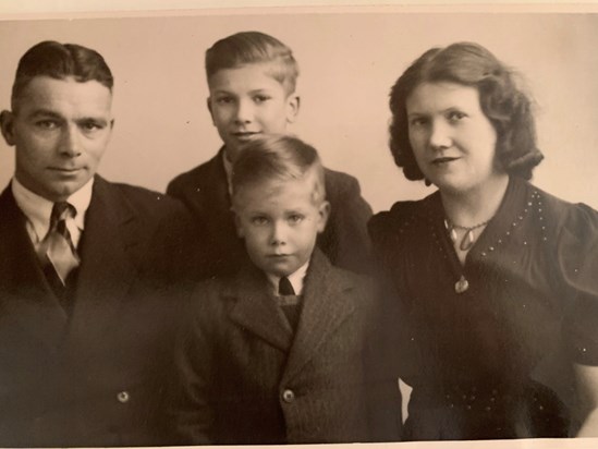 John (front) with brother Peter and Mum and Dad.