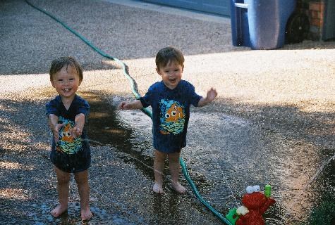 Caden and Ethan playing with the Elmo sprinkler