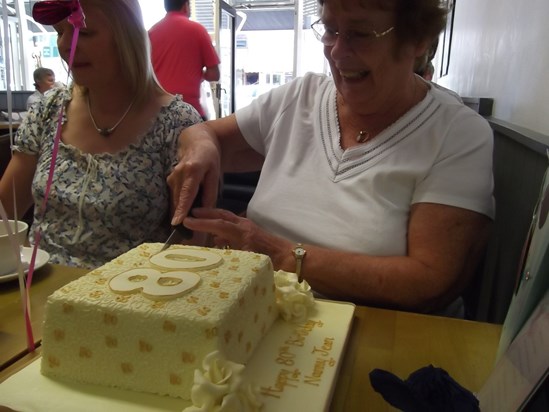 Jean cutting her 80th birthday cake 