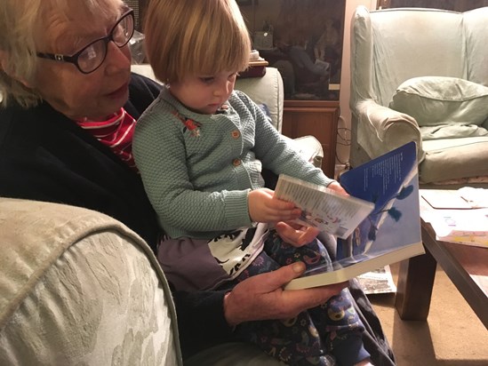 Reading with one of her granddaughters