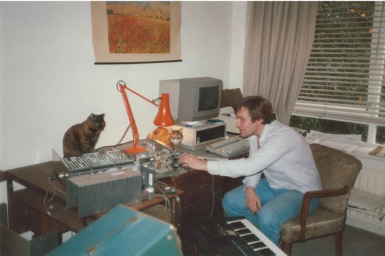 Chris working in his flat in Headington with Smokey and Josephine the cats, 1987