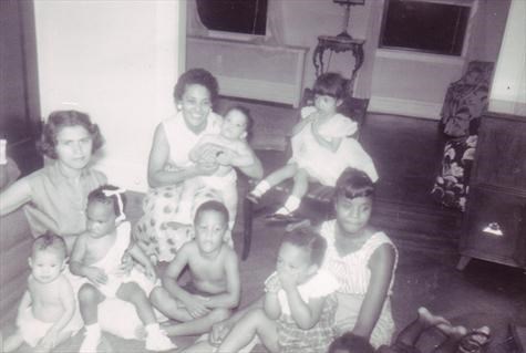 Little Kippy (center floor) in front of Mommy and little sister Sandra, with Aunt and cousins