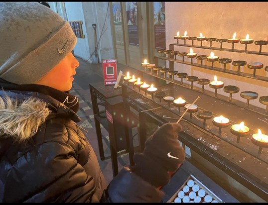Finley lighting a candle at St Albans Abbey