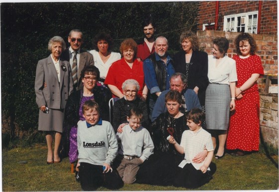 Barbara (red in centre) surrounded by family