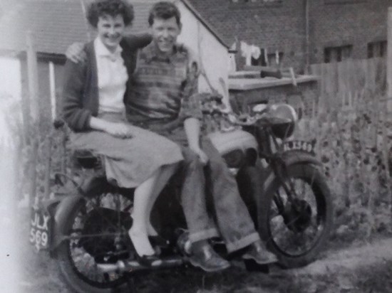 Margaret and Bobby posing on his motorbike.