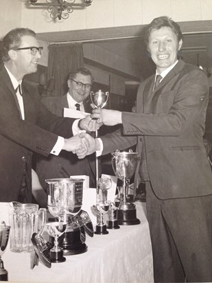 Ted being presented a trophy by professional player John Pulman.