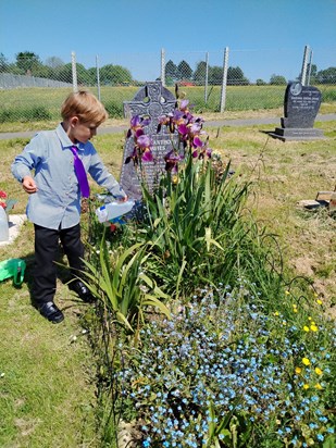 'Mini Craig' looking after Craig's grave flowers.