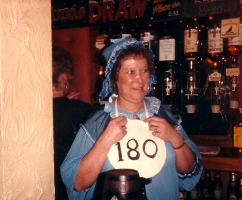 Mum celebrating getting 180 at Dart's. I think she was in fancy dress as Andy Pandy