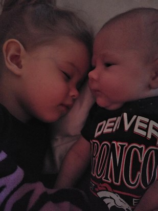 Big sister cuddling her baby brother
