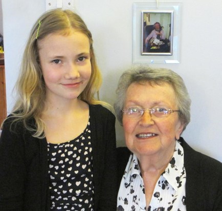 Gwen and great niece Lola with Gwen's sister in the photo behind