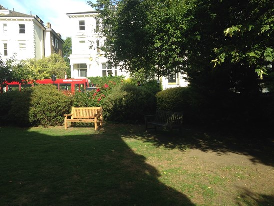 The bench in memory of Jhalib in its gloriously sunny spot in St Peter's Belsize Park church garden