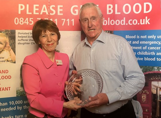 Receiving a gift in recognition of 76 pints of blood (2008). He went on to donate a further 20+!
