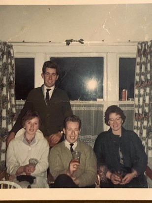 John and myself at home for Christmas from England having a drink with our neighbours. John is in his early 20s in this photo.