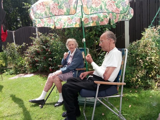 Mum and dad   enjoying the garden the sun and an icecream