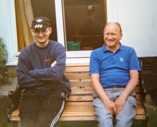 Dad with his grandson James enjoying the sunshine in the garden