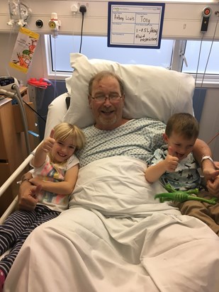 Poppy and Jack snuggling up to grandad.
