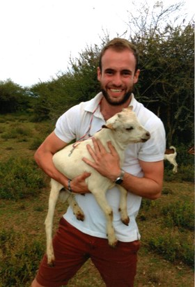 Laurie with his baby goat in Kenya