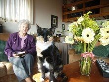 Oma, book, cat, flowers. . . a scene to encompass our darling Oma