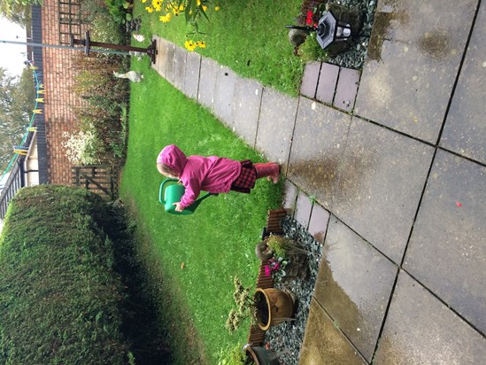 Ada watering Nana's garden... In the rain