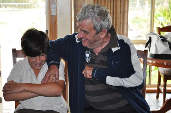 Geoff exercising during his battle 'holding grandson Tristan down so he wasn't  able to beat him'.