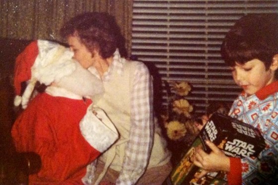 John, dressed as Santa, with Mom.